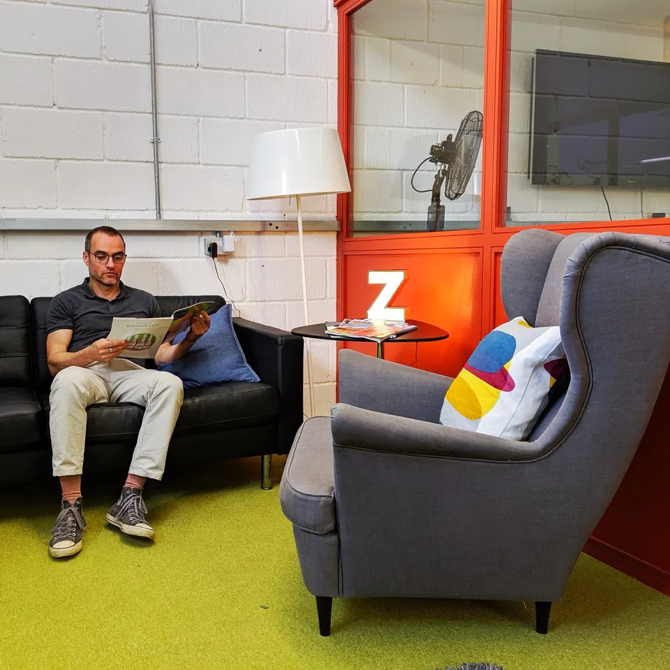 Reading on the sofa in the breakout space